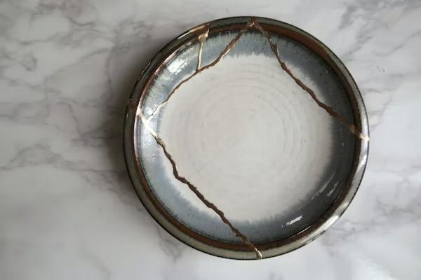 A kintsugi bowl, broken ceramic repaired with gold